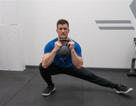 Front Rack Curtsy Lunges to Cossack Squat . 8 to 10 reps for each leg. Hold a pair of medium-sized kettlebells by the handle in the rack position, with the weights resting on your forearms. Brace ...